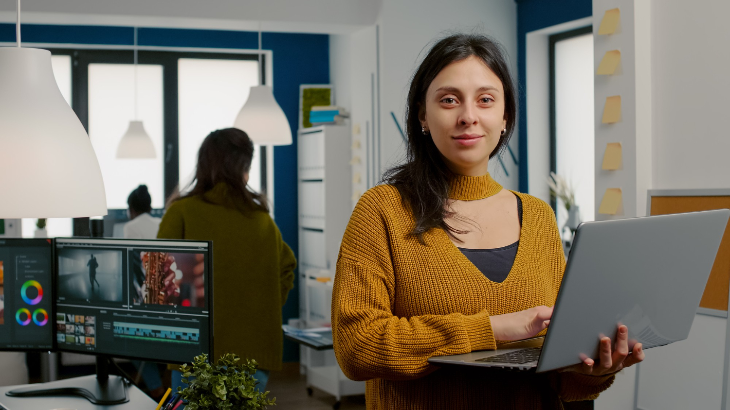 HR sector apprenticeship learner in yellow jumper sat at a computer