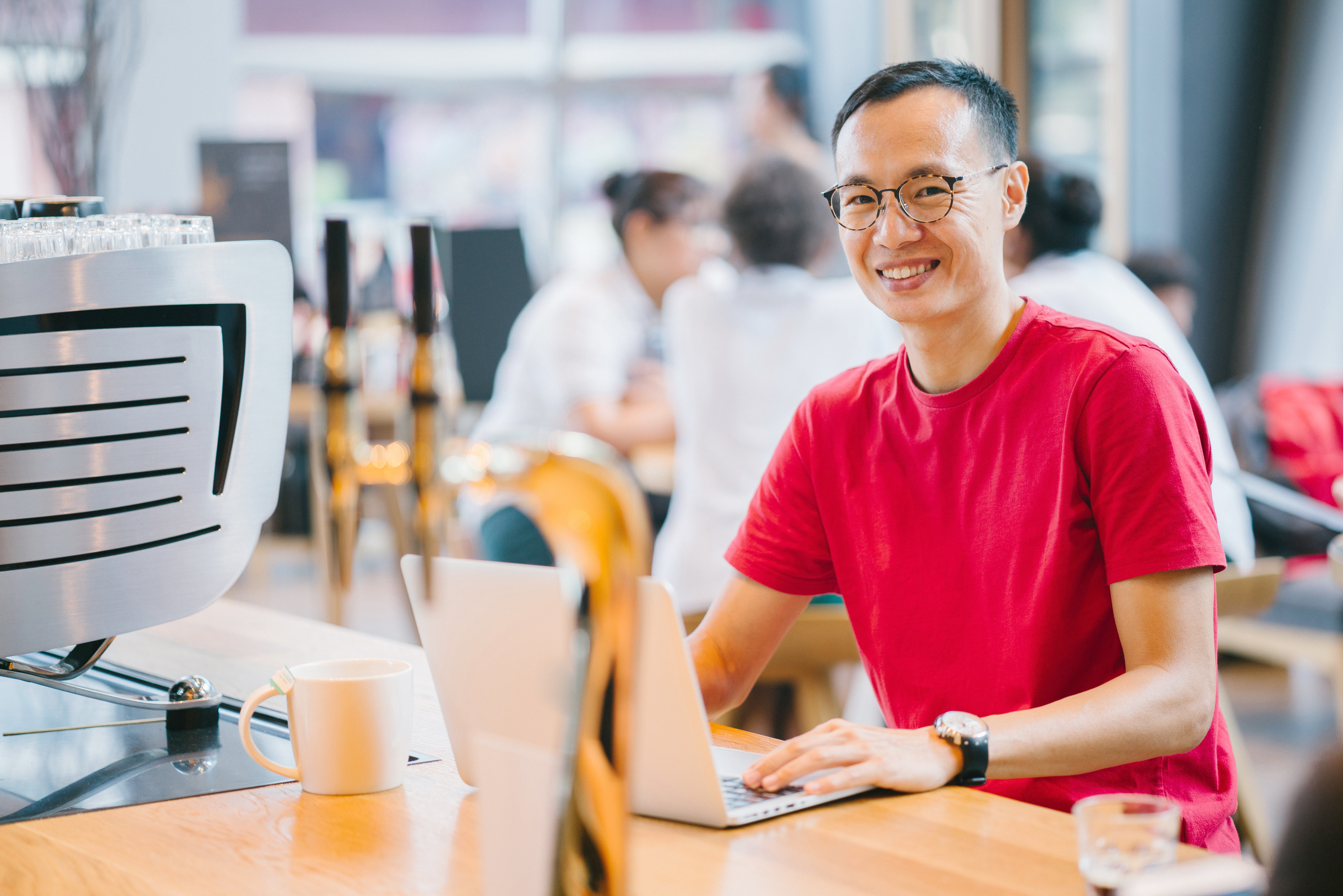 Data analyst wearing red tshirt sitting at desk