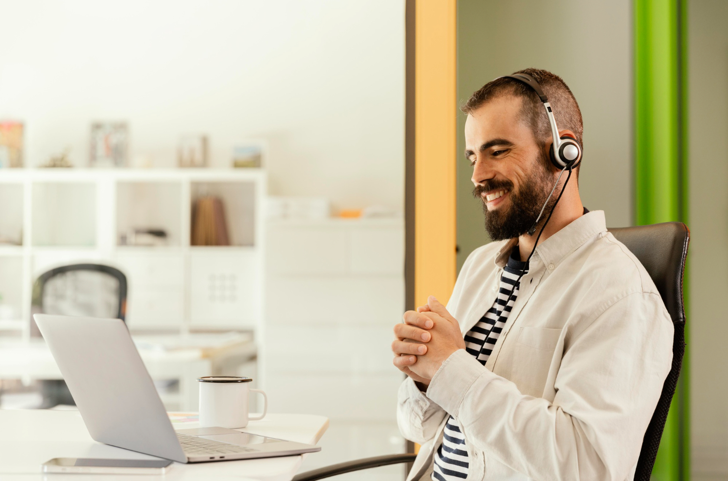 Male with headset sat at desk 