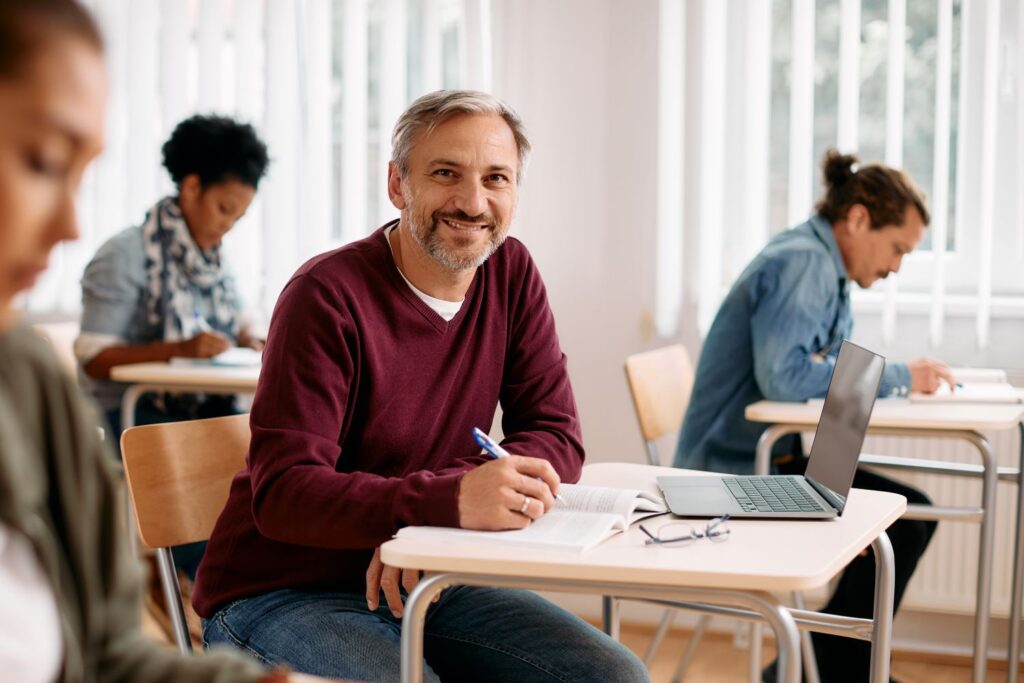 Happy mature learner sitting in on a mental health awareness session