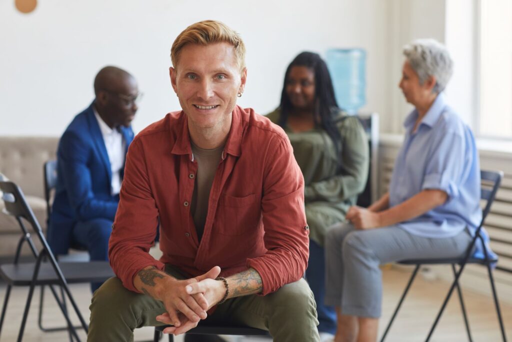 Conflict management session with a young blonde man leading 
