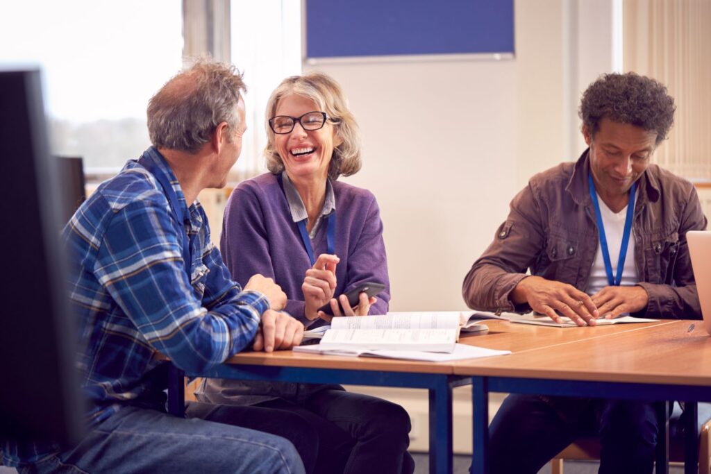 A group of mature students in a mental health awareness training session discussing the topics 