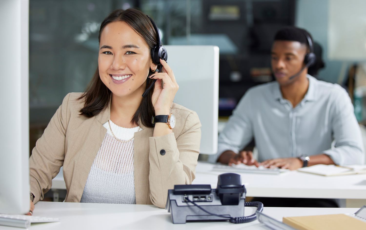 Customer service apprentice on the phone in an office environment